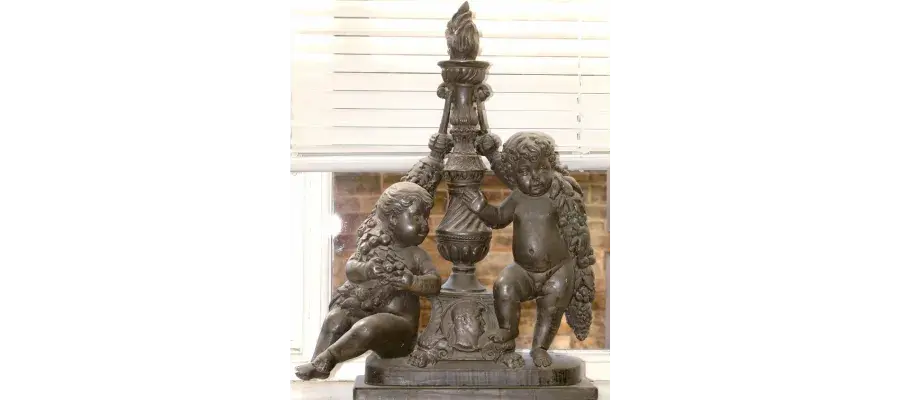 a metal statue of two children
