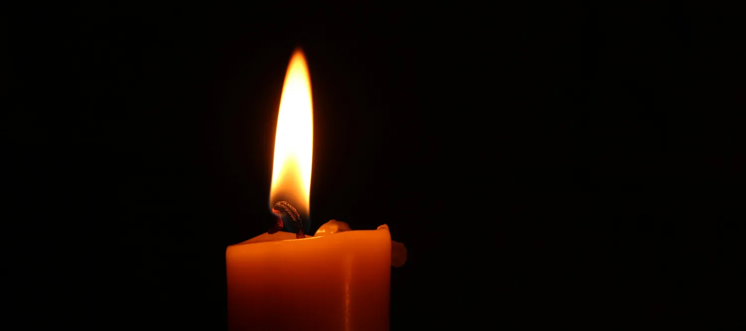 a candle shining in the dark