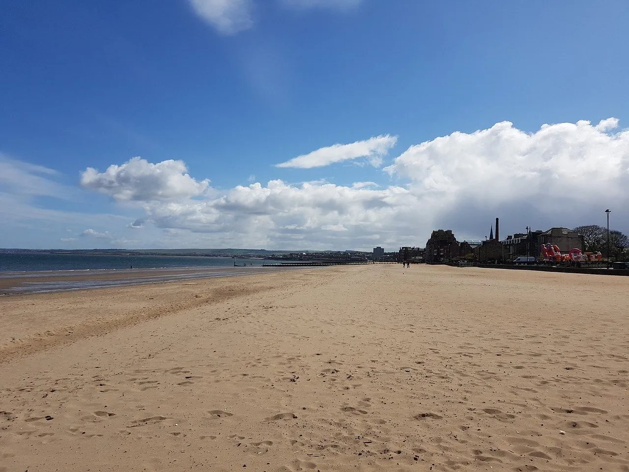 Photograph of Portobello beach, to the left is the River Forth and to the right of the image are the houses along the promenade