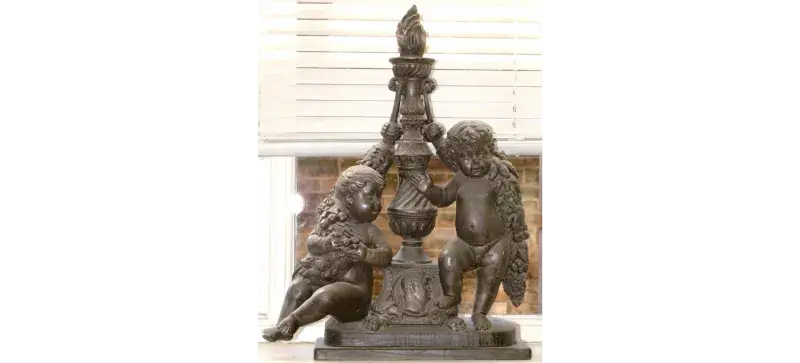 a metal statue of two children