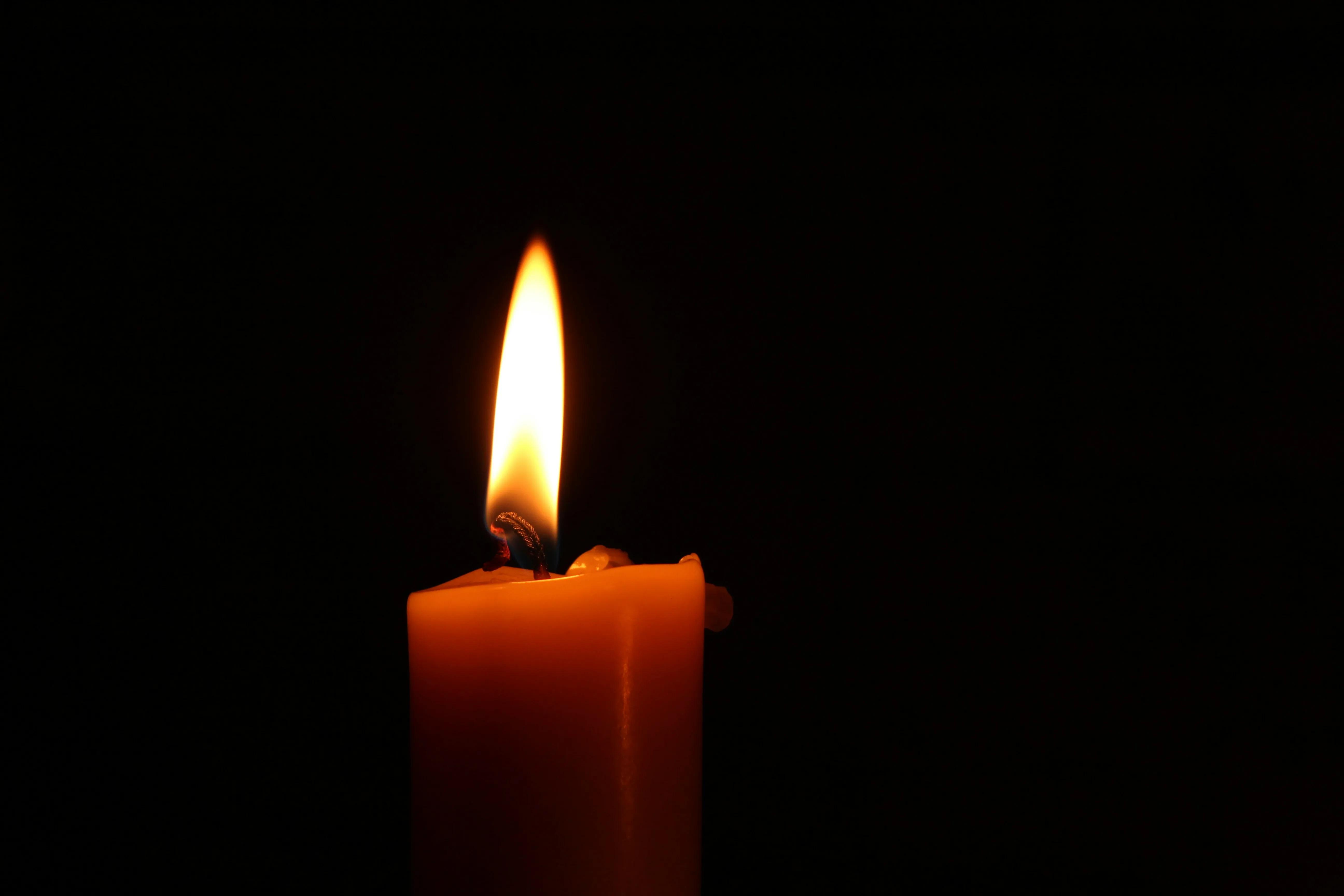a candle shining in the dark