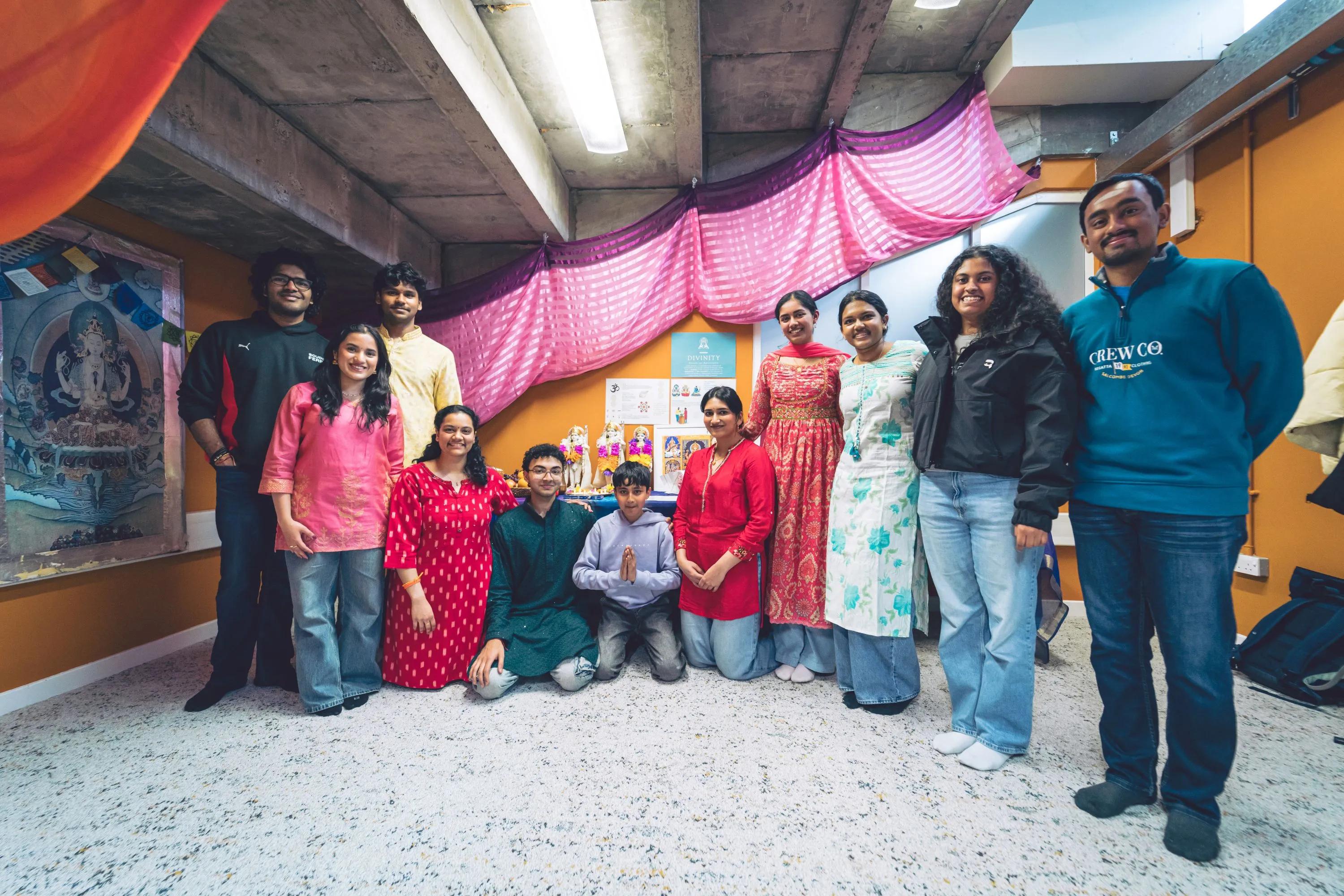a group of people standing in a half circle smiling