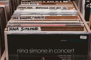 a selection of vinyl records in a record shop with Nina Simone at the front