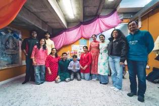 a group of people standing in a half circle smiling