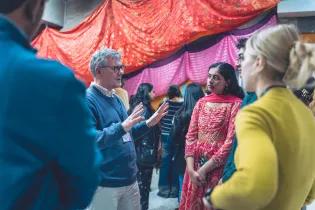 a man talking with a group of people