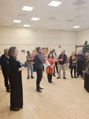 Harriet's manager giving a speech in the Chaplaincy Auditorium