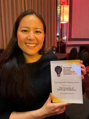 Lilian Lee holding an award