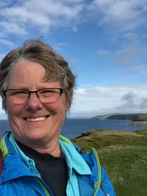 A photo of a Woman next to the Scottish shoreline