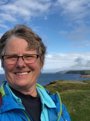 A photo of a Woman next to the Scottish shoreline