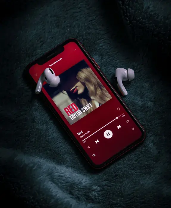 An ipod with a taylor swift album displayed on the screen