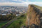 Photograph of Arthur's Seat in Holyrood Park, with Edinburgh city in the distance. 