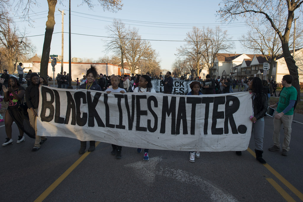 Photograph of a Black Lives Matter protest, with a Black Lives Matter banner. 