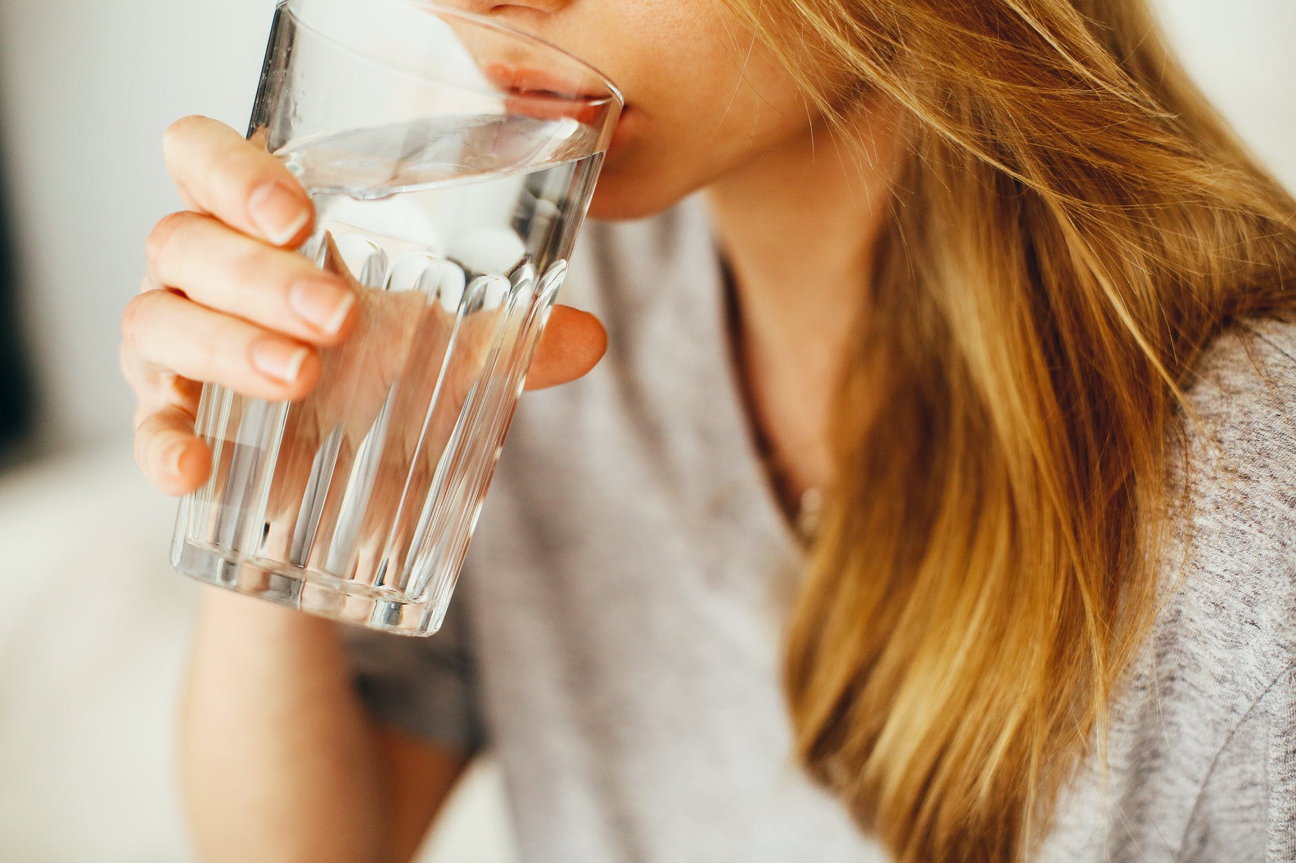 Photograph of woman drinking a glass of water