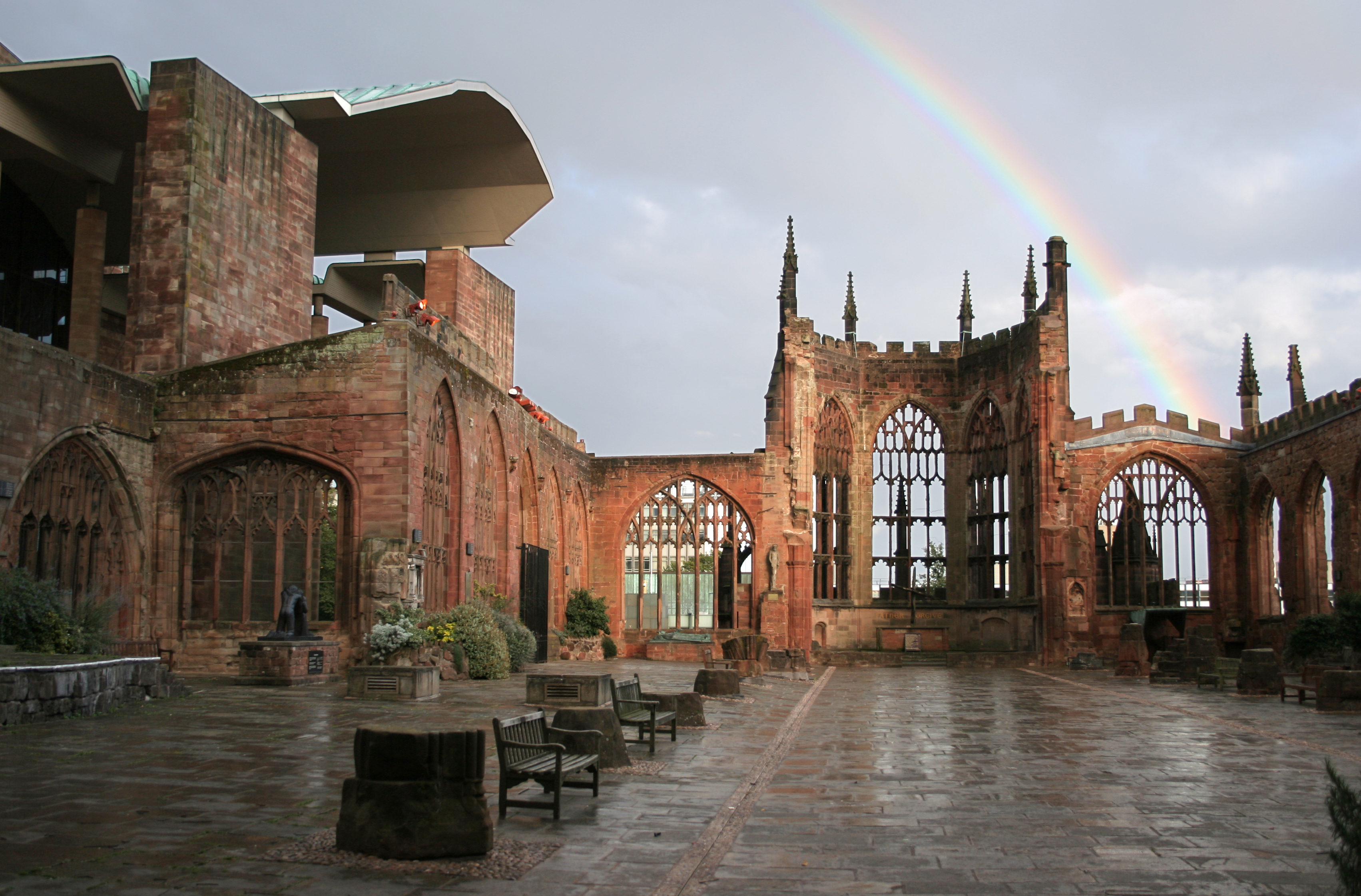 Photograph of Coventry Cathedral Ruins with Rainbow over the top of the ruins. 