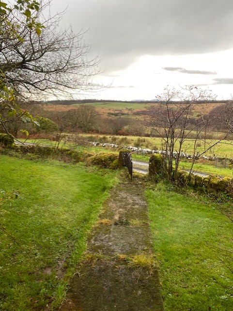 Photograph of a garden gate, overlooking hills