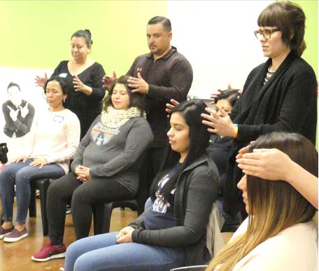 Photograph of head holds at the US Mexican border with community workers and human rights workers