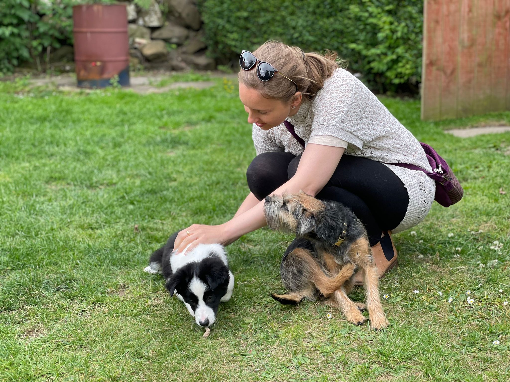 A woman petting a small puppy