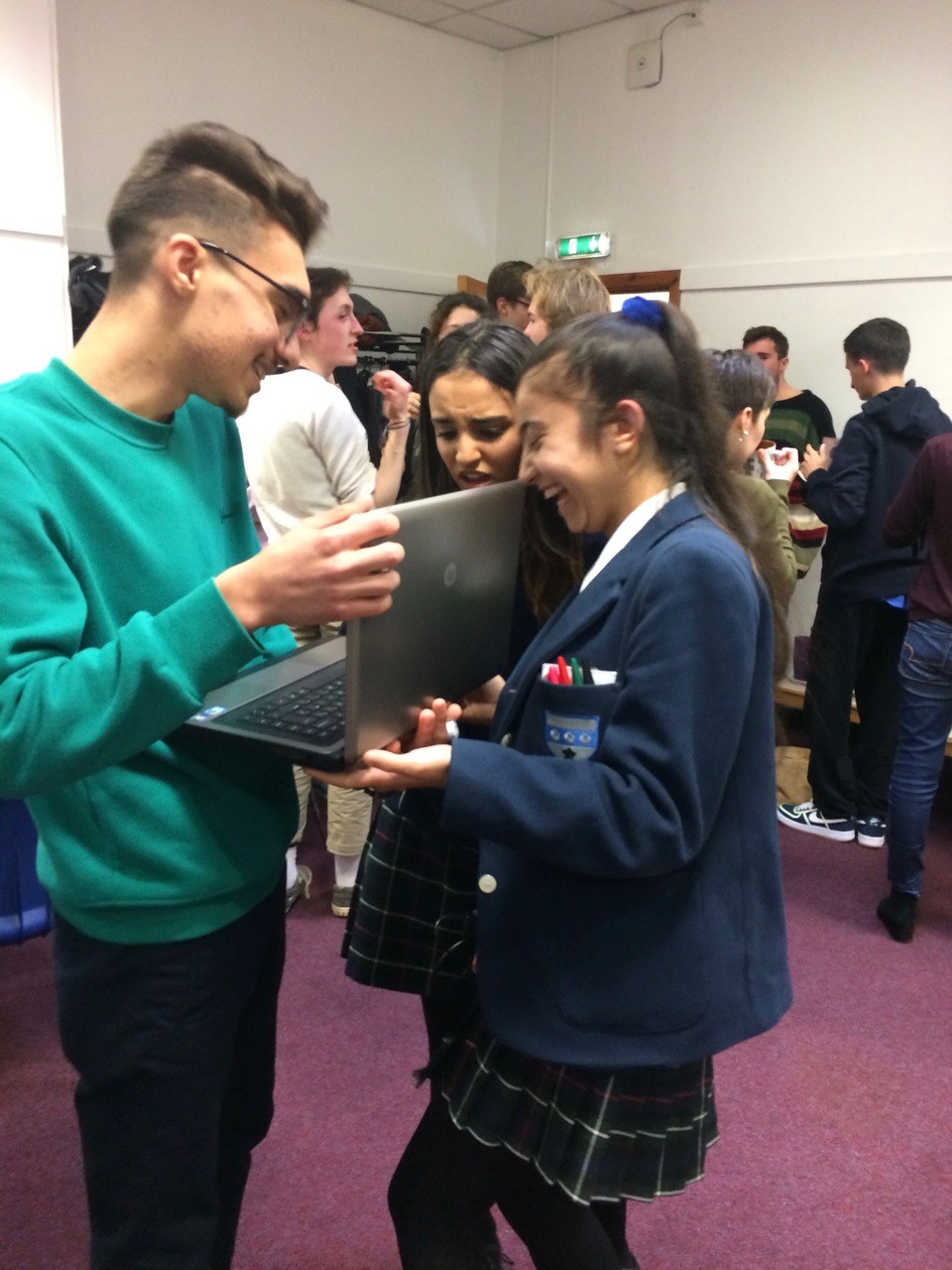 Photograph of Syrian teenagers receiving refurbished laptops